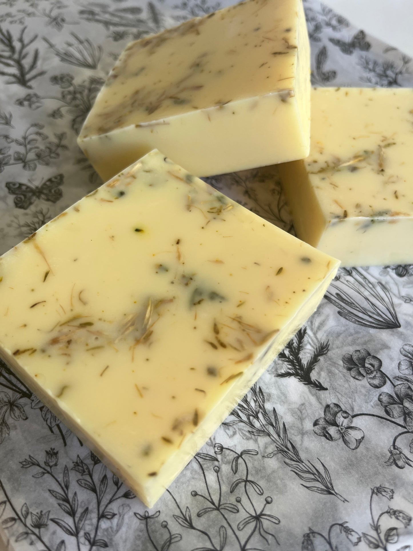 Three natural handmade soap bars with added herbs