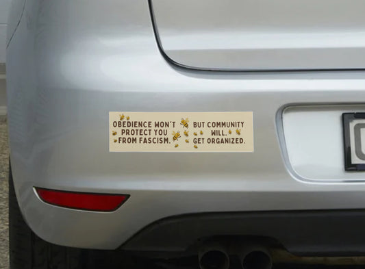 Bumper sticker on a car with text and symbols