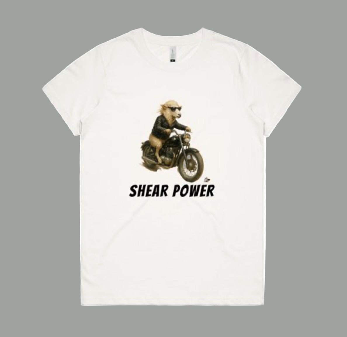 White t-shirt with a graphic of a sheep on a motorcycle and 'Shear Power' text on a white background