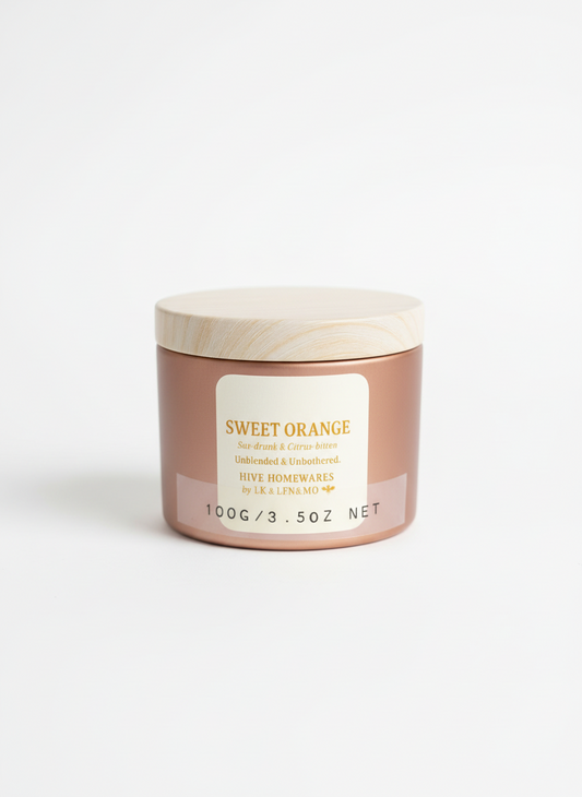 Jar of 'Sweet Orange' candle on a white background