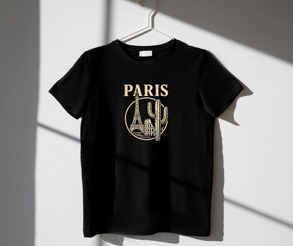 Black t-shirt with 'PARIS' and skyline design on a hanger against a white wall.