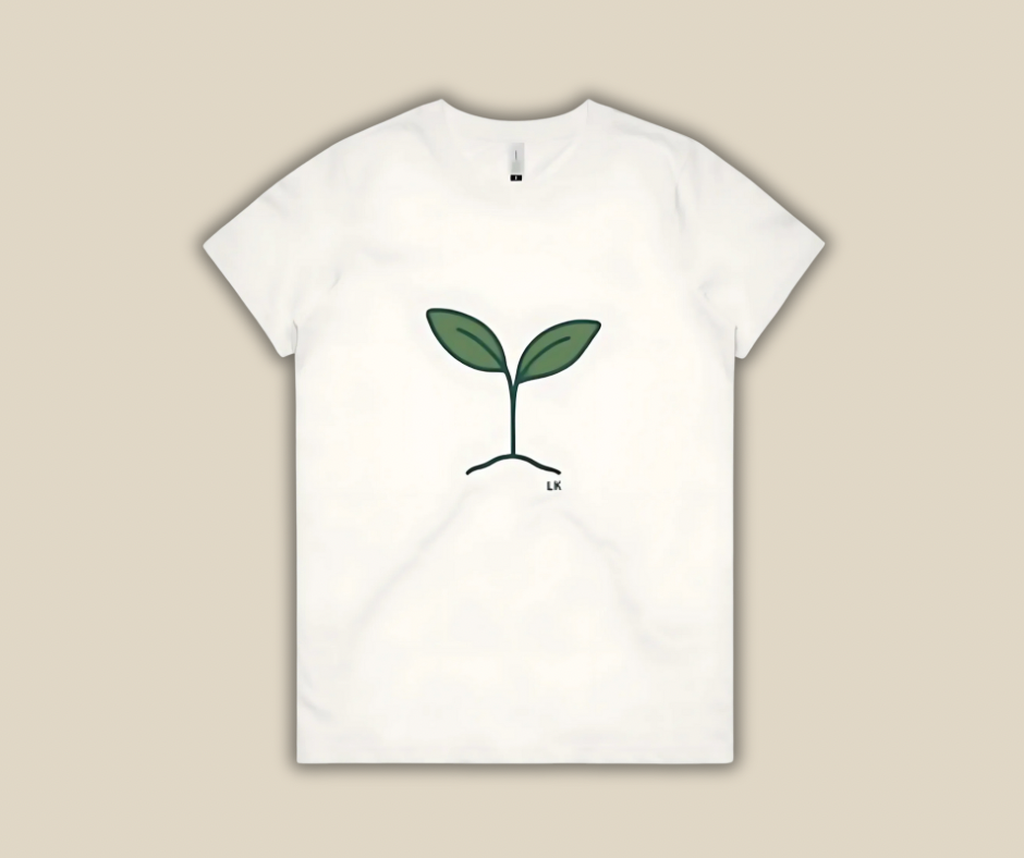 White t-shirt with a green plant design on a beige background