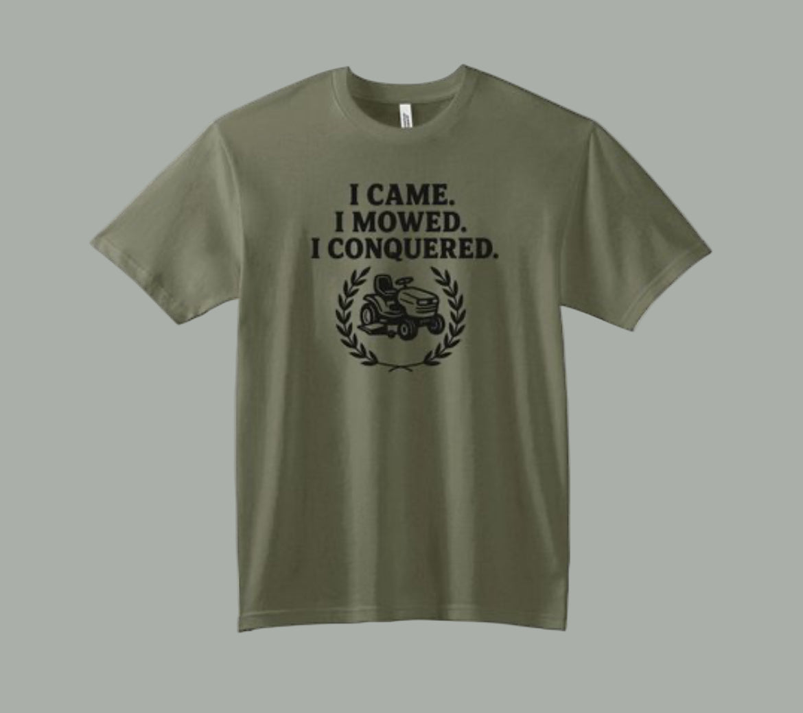 Green t-shirt with humorous lawn mower graphic and text on a white background