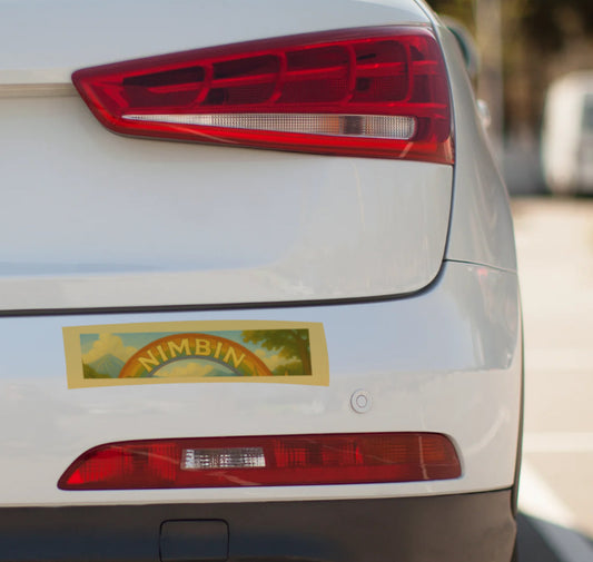 Car tail light with a 'Nimbin' sticker on a white car
