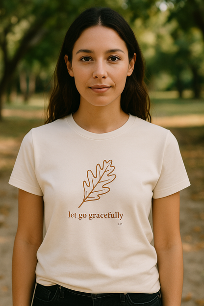 Woman wearing a white t-shirt with a leaf design and text in a natural setting