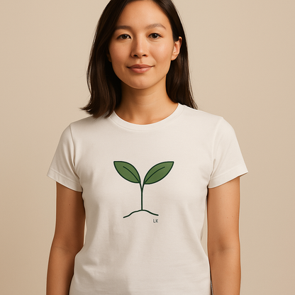 Person wearing a white t-shirt with a green plant design on a beige background