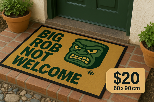 Satirical doormat reading ‘Big Rob Not Welcome’ in bold protest-style lettering, featuring an angry cartoon face and Hive Homewares bee logo. Designed in Lismore as grassroots political commentary.