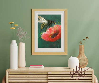 Framed artwork of a bee on a flower above a wooden console table with decorative items.