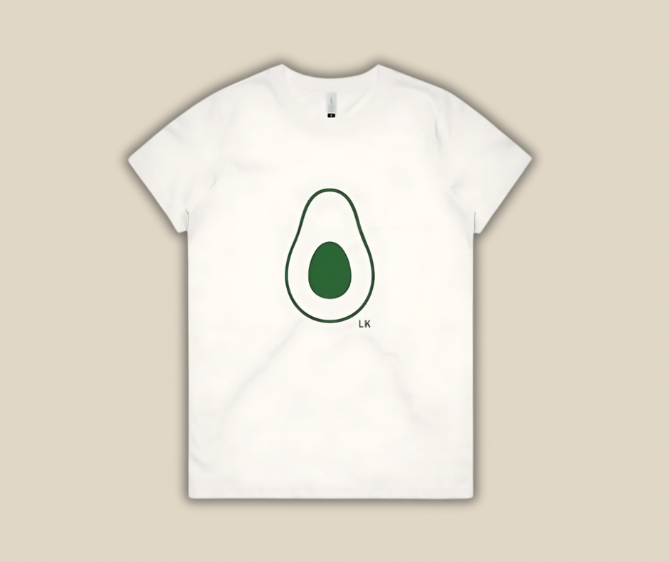 White t-shirt with avocado graphic on a beige background