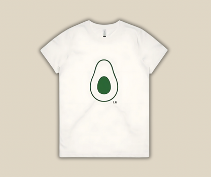 White t-shirt with avocado graphic on a beige background