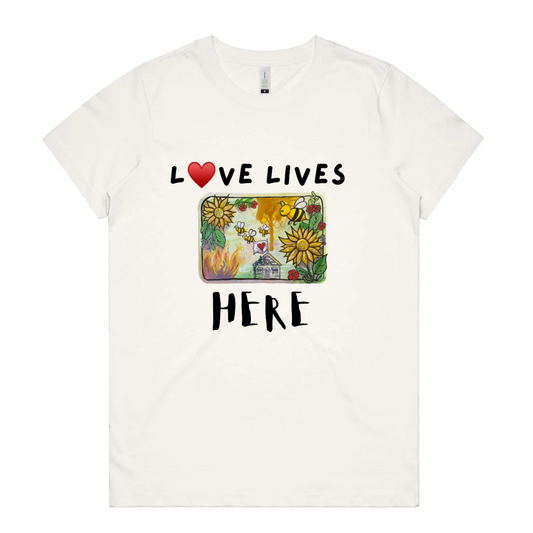 White t-shirt with 'Love Lives Here' graphic and text on a white background